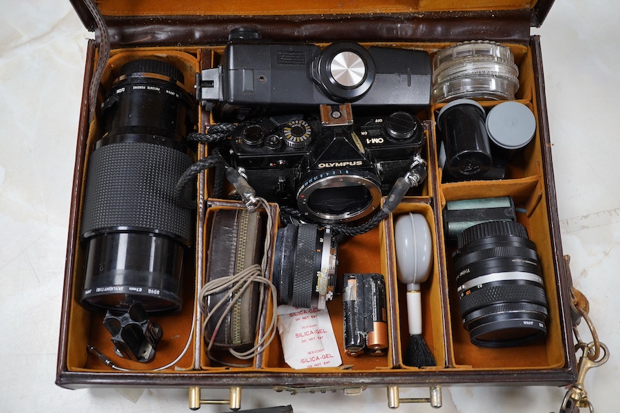 A cased Olympus camera, lenses and equipment, Condition - poor